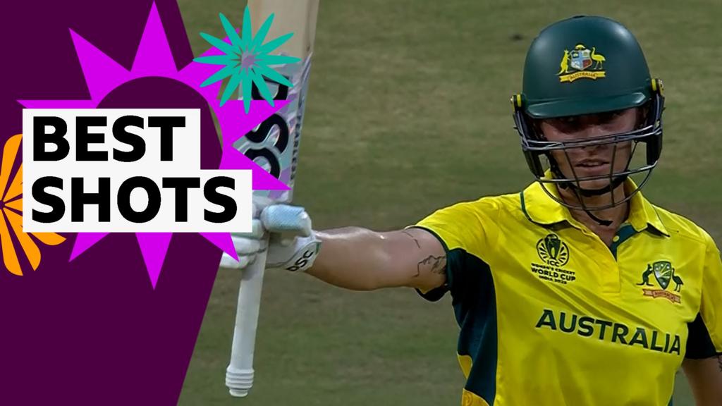 Ash Garnder raises her bat to celebrate reaching her century