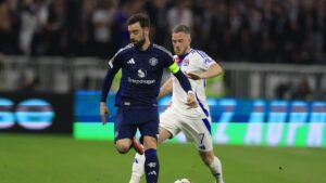 Manchester United's Bruno Fernandes (L) and  Lyon's Jordan Veretout in action during the UEFA Europa League quarterfinals 1st leg match, Lyon, France, April 10, 2025. (EPA Photo)