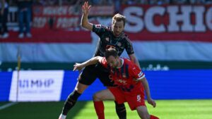 Bayern Munich's Harry Kane (L) and Heidenheim's Benedikt Gimber vie for the ball during the German first division Bundesliga football match between Heidenheim and Bayern Munich, Heidenheim, Germany, April 19, 2025. (AFP Photo)