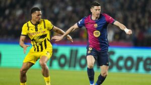 Barcelona's Robert Lewandowski (R) escapes from Borussia Dortmund's Felix Nmecha during the UEFA Champions League quarterfinal first leg match at the Estadio Olimpico Lluis Companys, Barcelona, Spain, April 9, 2025. (EPA Photo)
