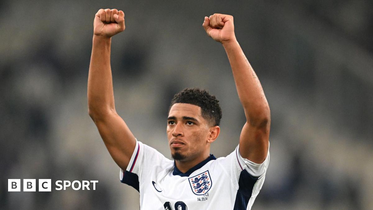 Jude Bellingham holds his fists in the air to celebrate an England victory against Greece in November 2024