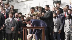 Ohio State University football player TreVeyon Henderson (C-L), catches the top of the team's championship trophy after US Vice President JD Vance tries to pick it up during a ceremony to honor the Ohio State University Buckeyes football team on their 2025 College Football National Championship on the South Lawn of the White House, Washington, U.S., April 14, 2025. (EPA Photo)