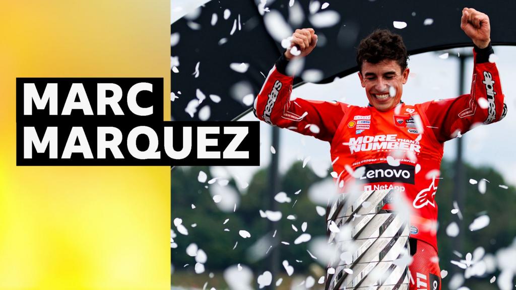 Marc Marquez celebrates with the MotoGP World trophy