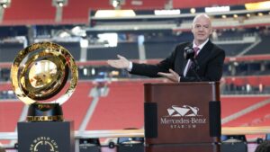 FIFA President Gianni Infantino gestures toward the FIFA World Cup trophy during a news conference at Mercedes-Benz Stadium, Atlanta, U.S., April 14, 2025. (AP Photo)