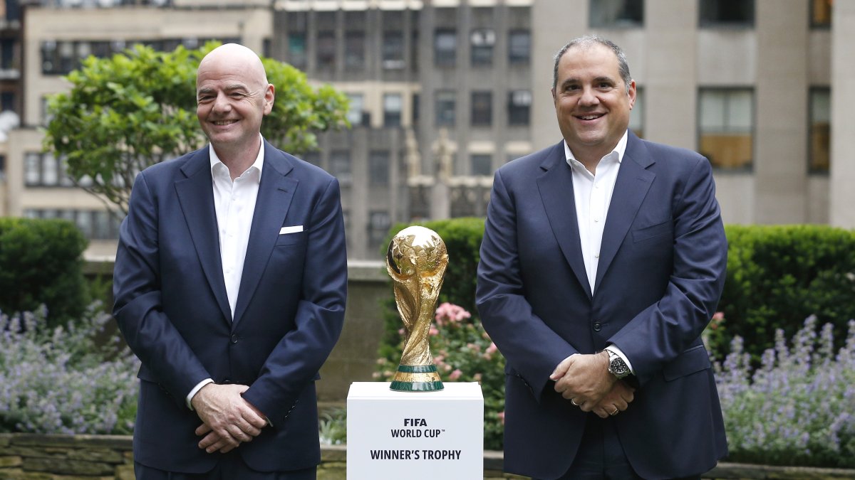 FIFA President Gianni Infantino (L) and Vice President, CONCACAF President Victor Montagliani stand with the FIFA World Cup trophy,  New York, U.S., June 16, 2022. (AP Photo)