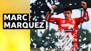 Marc Marquez celebrates with the MotoGP World trophy